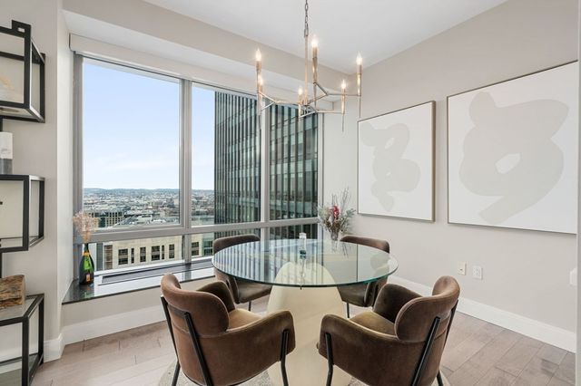 a dining room with furniture a chandelier and window