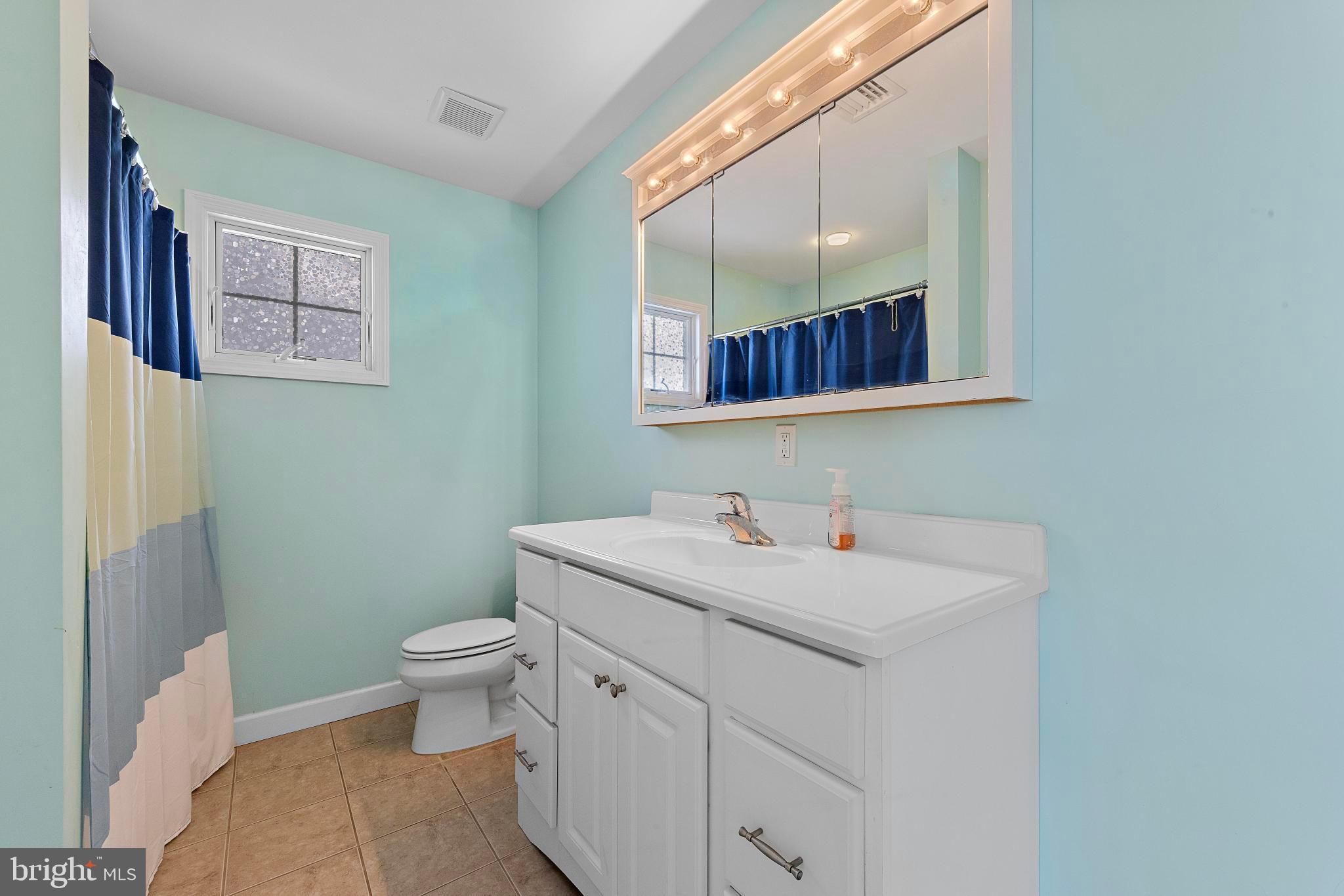 27 Parker Road Tuckerton, NJ 08087 - Photo 14 of 24 a bathroom with a toilet sink and mirror