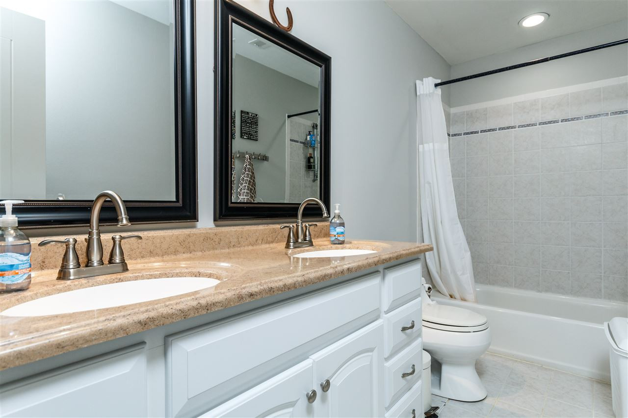 3412 1st Place Raleigh, NC 27613 - Photo 20 of 25 Granite counters with double vanity. Decorative tile. Hall bath