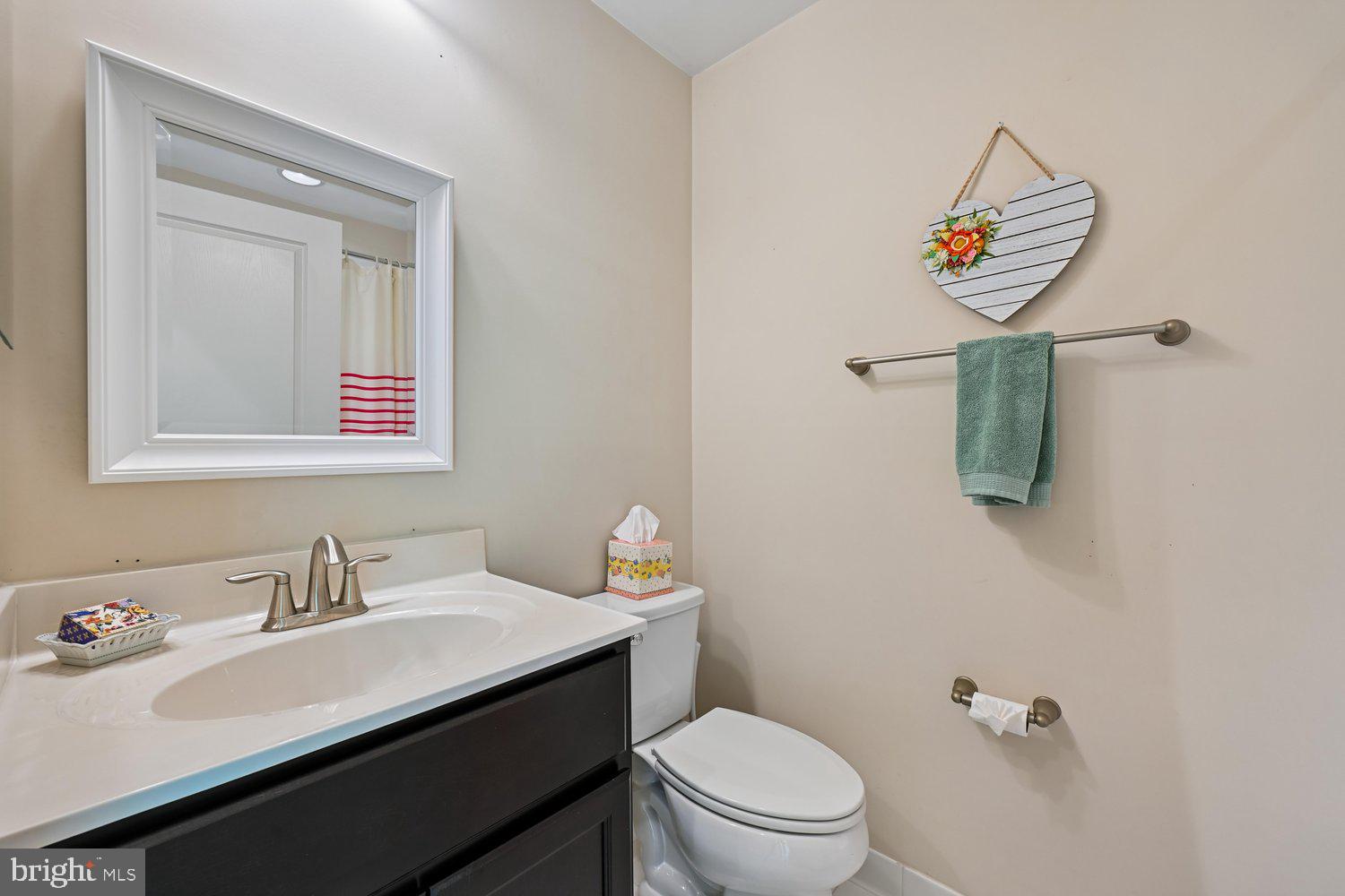 3068 Spring Peeper Court Odenton, MD 21113 - Photo 15 of 42 a bathroom with a sink a toilet and mirror