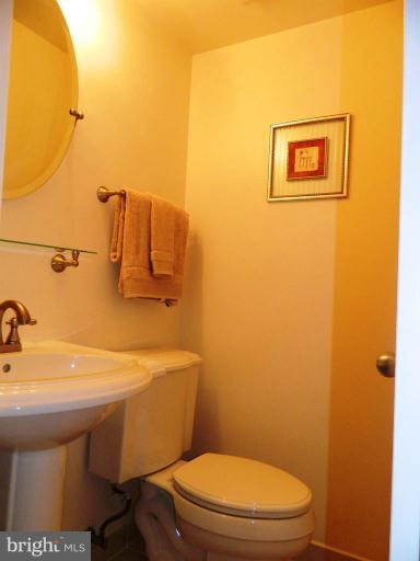 13289 Kenny Road Woodbridge, VA 22193 - Photo 13 of 23 a bathroom with a toilet a sink and mirror