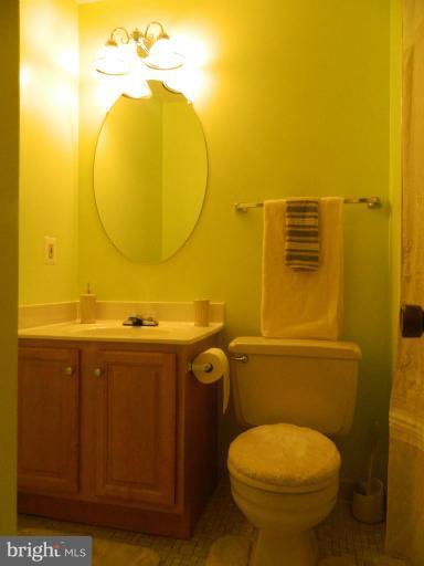 13289 Kenny Road Woodbridge, VA 22193 - Photo 16 of 23 a bathroom with a toilet mirror and vanity