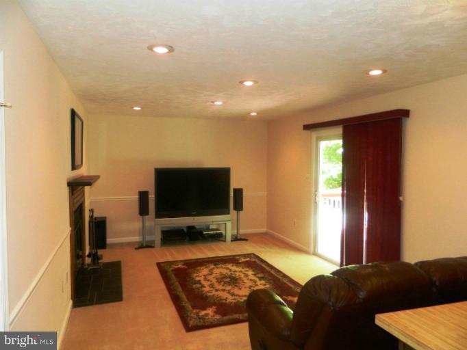13289 Kenny Road Woodbridge, VA 22193 - Photo 20 of 23 a living room with furniture and a flat screen tv
