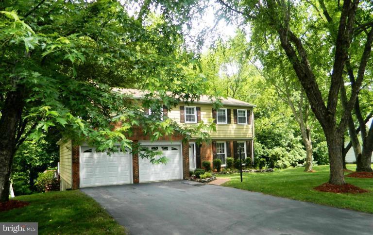 13289 Kenny Road Woodbridge, VA 22193 - Photo 5 of 23 a front view of a house with a yard and trees