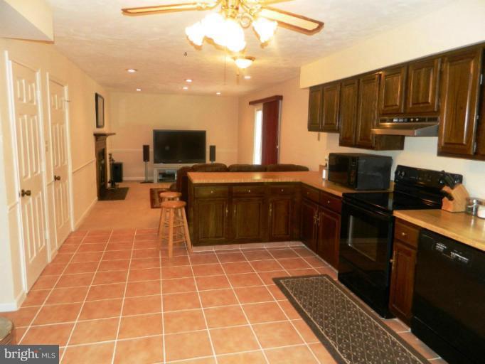 13289 Kenny Road Woodbridge, VA 22193 - Photo 6 of 23 a kitchen with stainless steel appliances a stove sink and cabinets