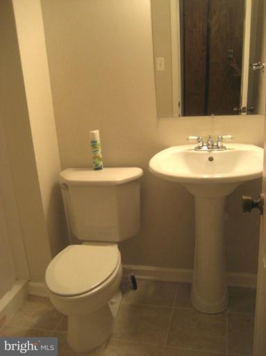 13289 Kenny Road Woodbridge, VA 22193 - Photo 8 of 23 a bathroom with a sink a toilet and a mirror