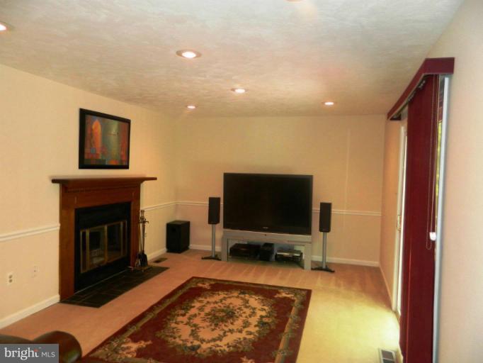 13289 Kenny Road Woodbridge, VA 22193 - Photo 9 of 23 a living room with a flat screen tv and a fireplace