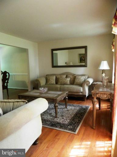 13289 Kenny Road Woodbridge, VA 22193 - Photo 10 of 23 a living room with furniture and a rug