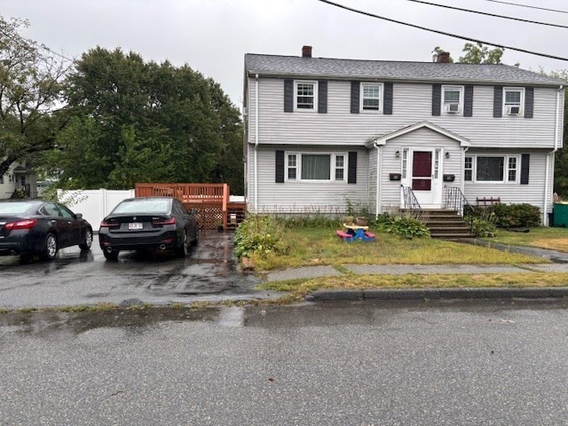 4 Bartlett Drive, Unit A Woburn, MA 01801 - Photo 2 of 14 a view of a white house next to a yard with big trees