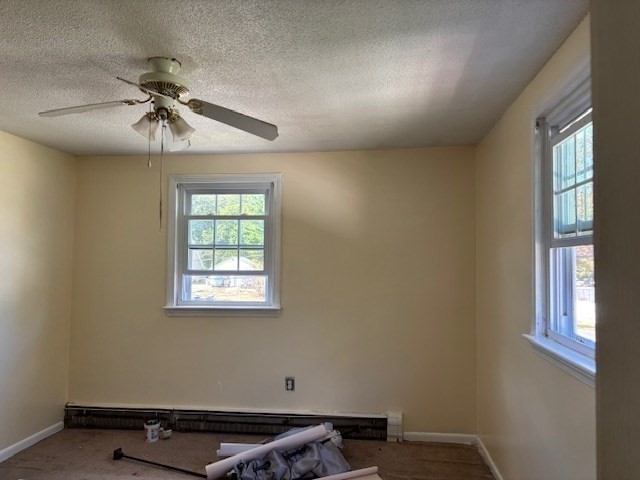 4 Bartlett Drive, Unit A Woburn, MA 01801 - Photo 10 of 14 an empty room with windows and fan