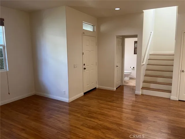 a view of an entryway with wooden floor
