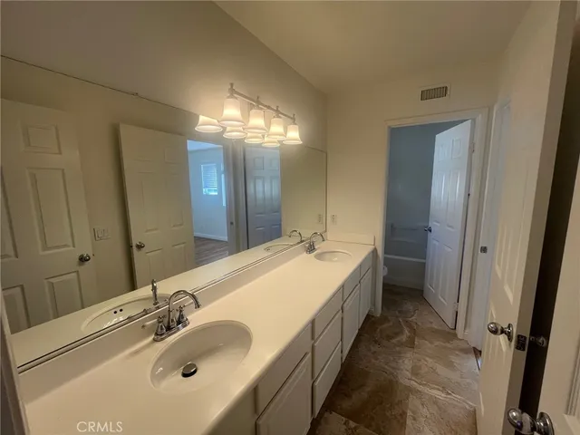 a white toilet sitting next to a bath tub