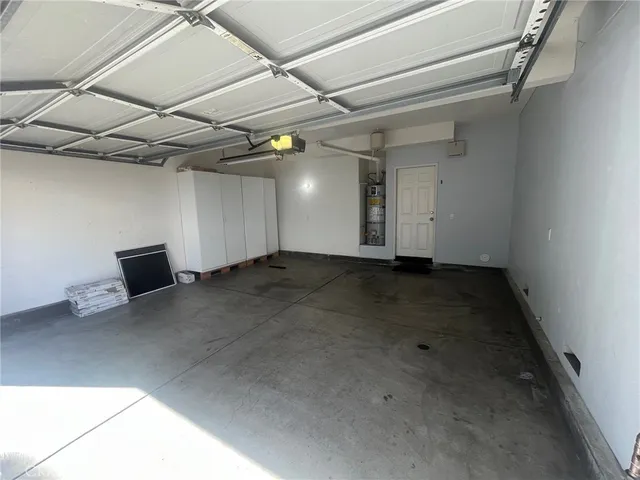 a front view of a house with a tree