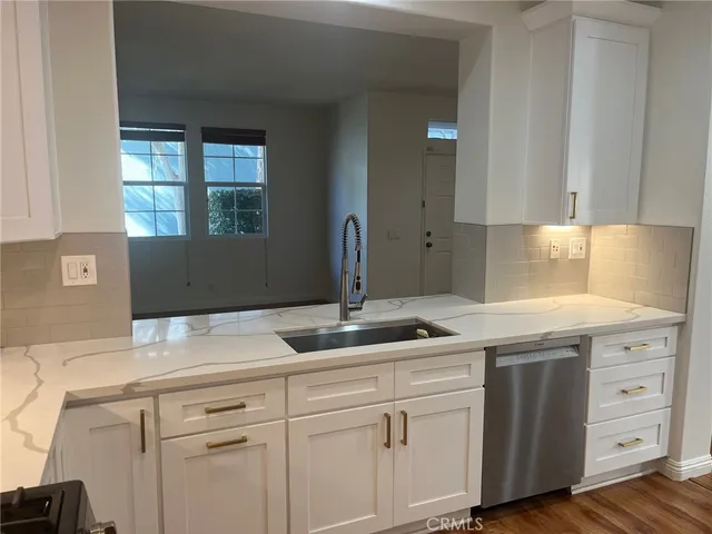 a kitchen with a sink and cabinets
