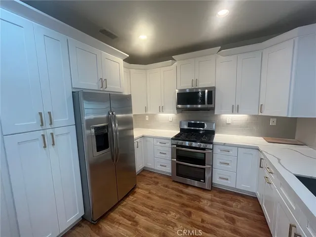 a kitchen with a sink and steel stainless steel appliances