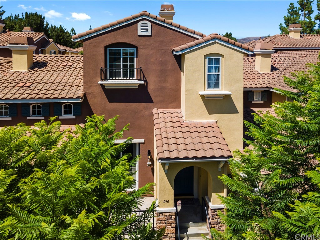 210 Timberwood Irvine, CA 92620 - Photo 1 of 1 a front view of a house with a garden