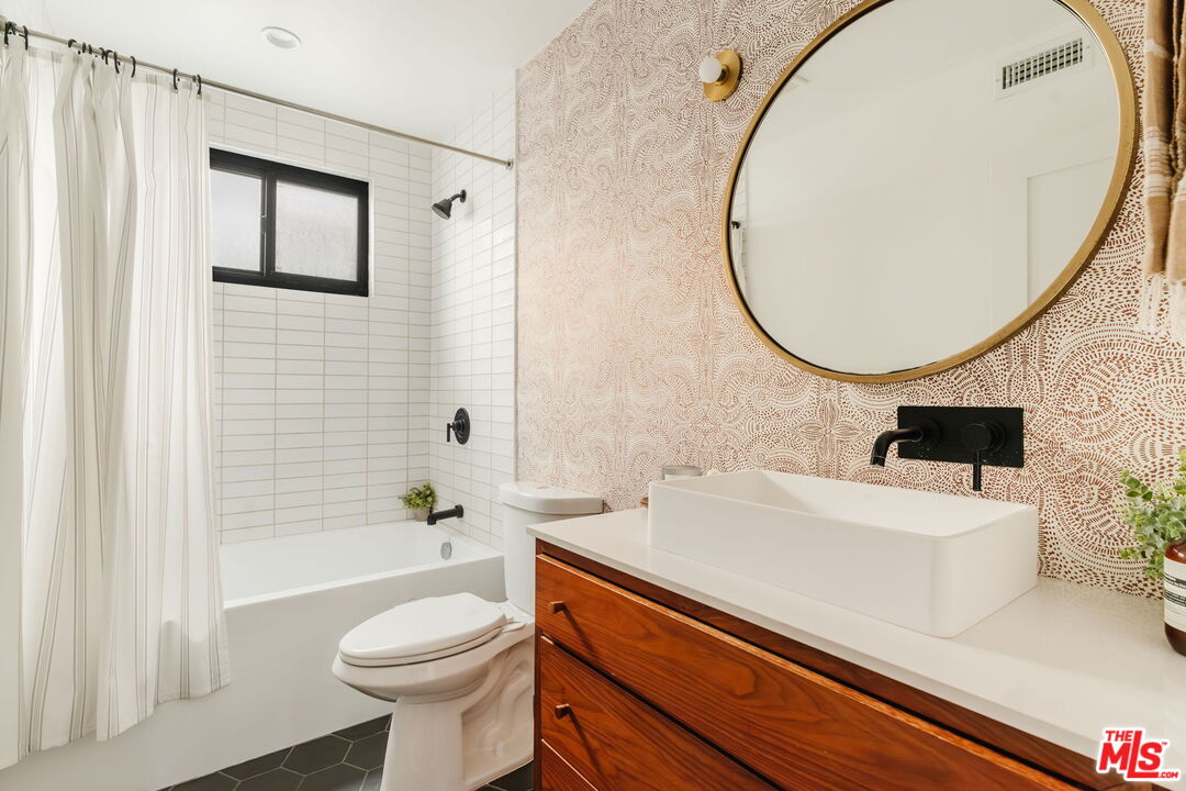 1943 12th, Unit 2 Santa Monica, CA 90404 - Photo 24 of 38 a bathroom with a sink a toilet and a mirror