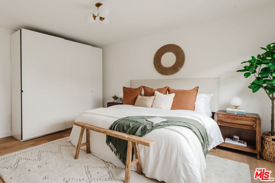 1943 12th, Unit 2 Santa Monica, CA 90404 - Photo 30 of 38 a bedroom with a bed and a potted plant