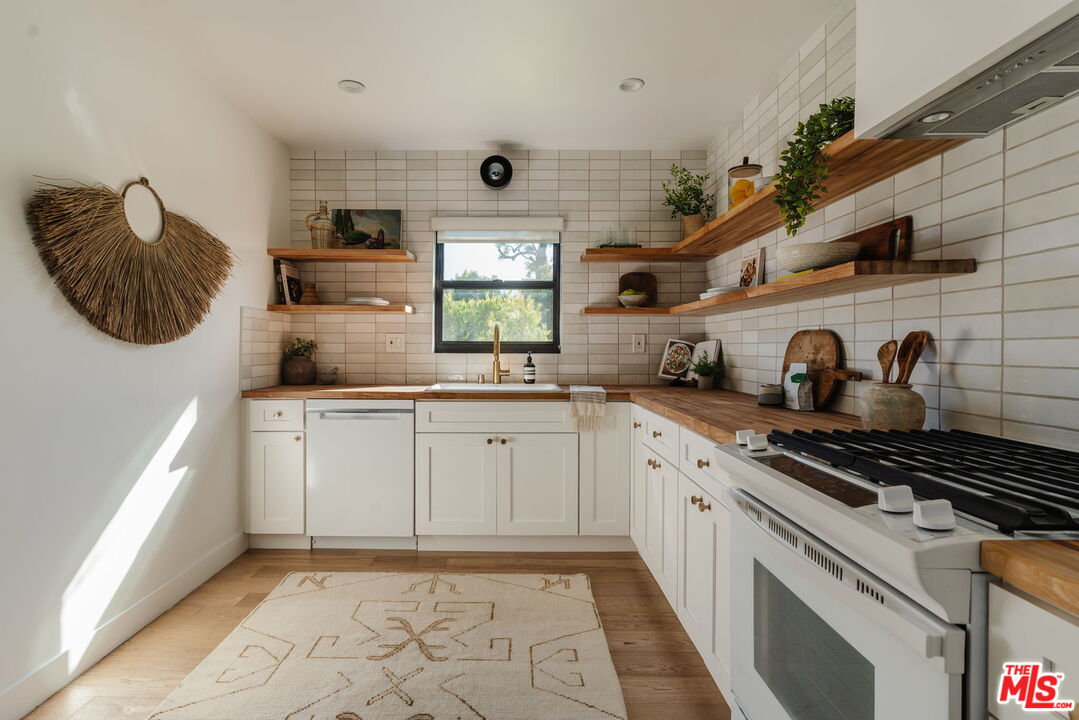 1943 12th, Unit 2 Santa Monica, CA 90404 - Photo 38 of 38 a kitchen with granite countertop a sink and cabinets