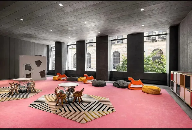 a bedroom with furniture toys and a large window