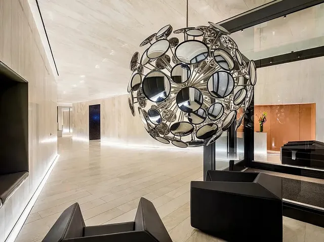 a view of a hallway with couches and dinning table