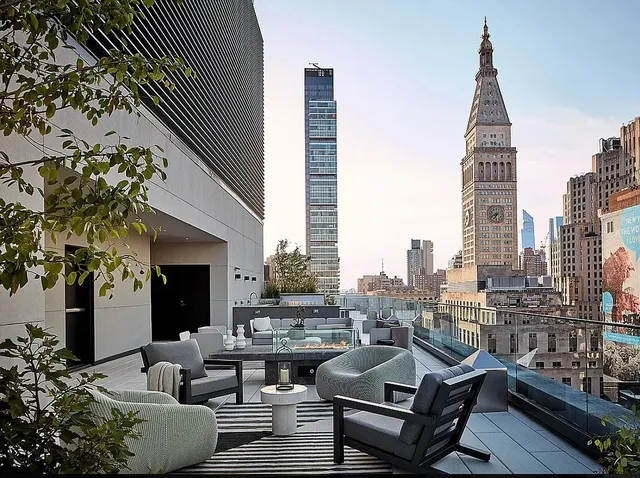 a view of a roof deck with couches and potted plants