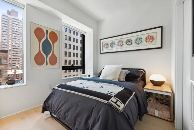 a bedroom with a bed and wall painting