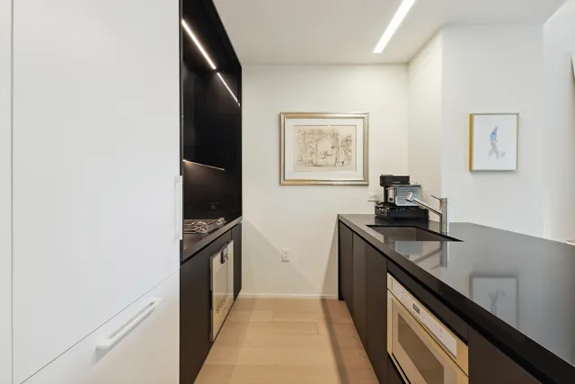 a kitchen with granite countertop a stove and a refrigerator