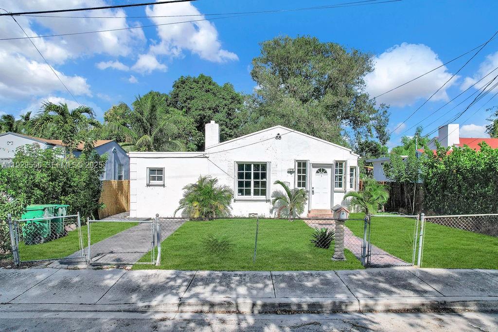 47 Northwest 49th Street, Unit 3 Miami, FL 33127 - Photo 13 of 47 a front view of a house with a yard and trees