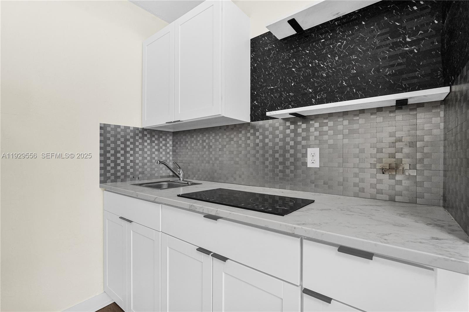 47 Northwest 49th Street, Unit 3 Miami, FL 33127 - Photo 3 of 47 a kitchen with a sink and cabinets
