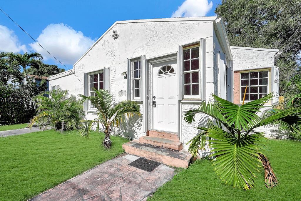 47 Northwest 49th Street, Unit 3 Miami, FL 33127 - Photo 36 of 47 a front view of house and yard with green space