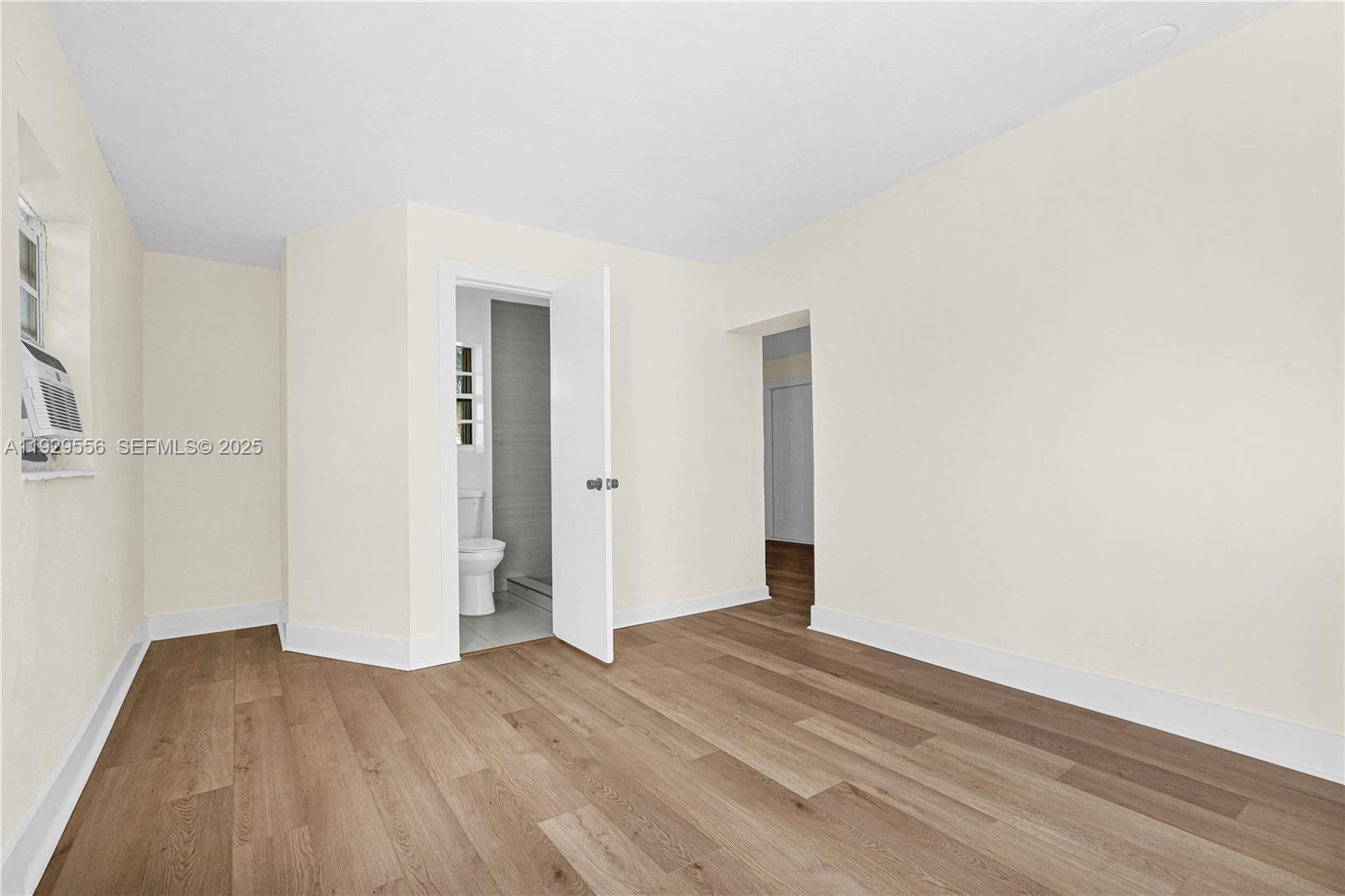 47 Northwest 49th Street, Unit 3 Miami, FL 33127 - Photo 4 of 47 a view of an empty room with wooden floor