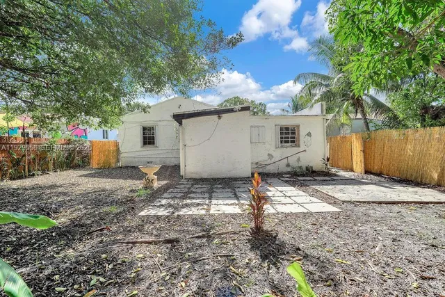 a backyard of a house with table and chairs