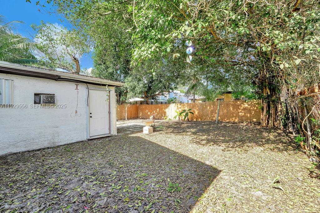 47 Northwest 49th Street, Unit 3 Miami, FL 33127 - Photo 46 of 47 a view of a backyard with large trees