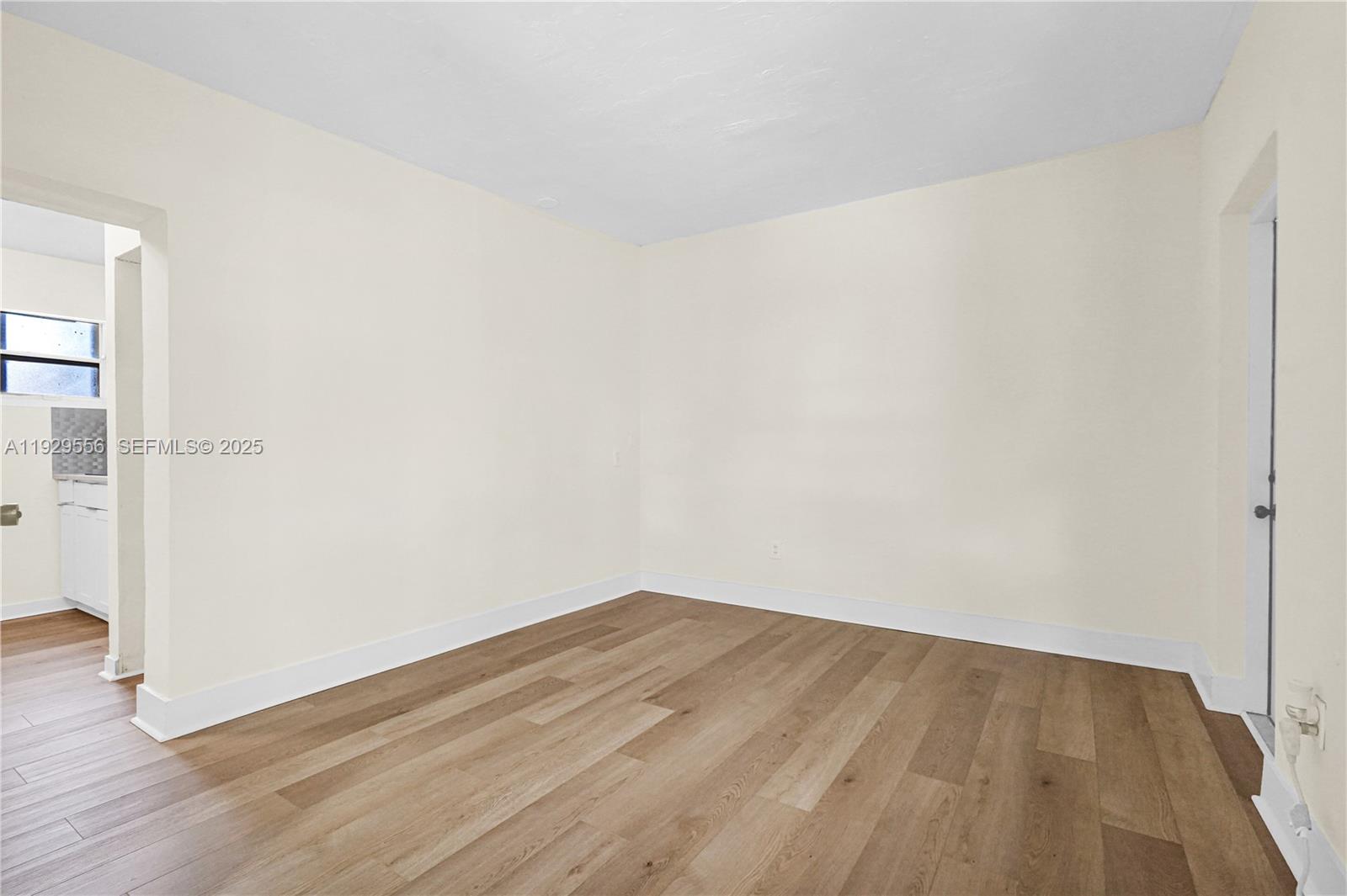 47 Northwest 49th Street, Unit 3 Miami, FL 33127 - Photo 7 of 47 an empty room with wooden floor and windows