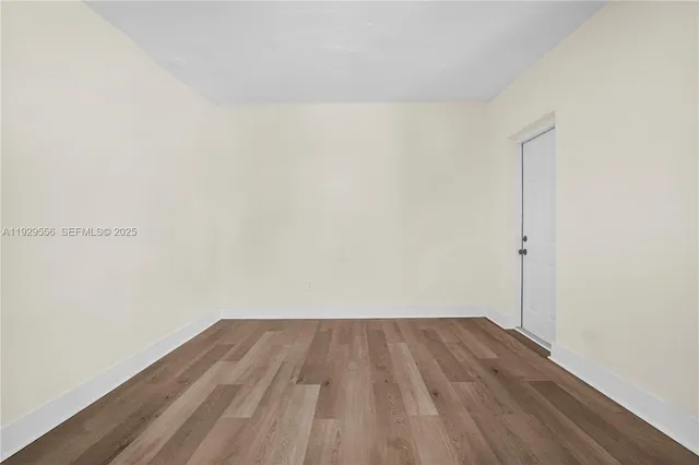 a view of a room with wooden floor