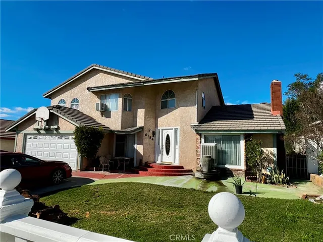 a front view of a house with a garden and porch