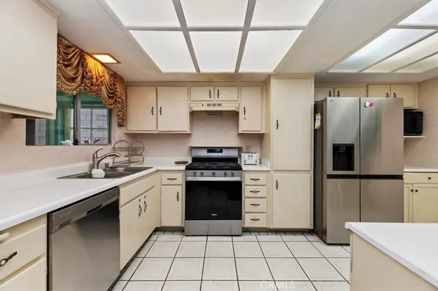 a kitchen with a stove a refrigerator and a sink