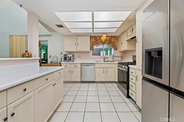 a kitchen with a sink window and cabinets
