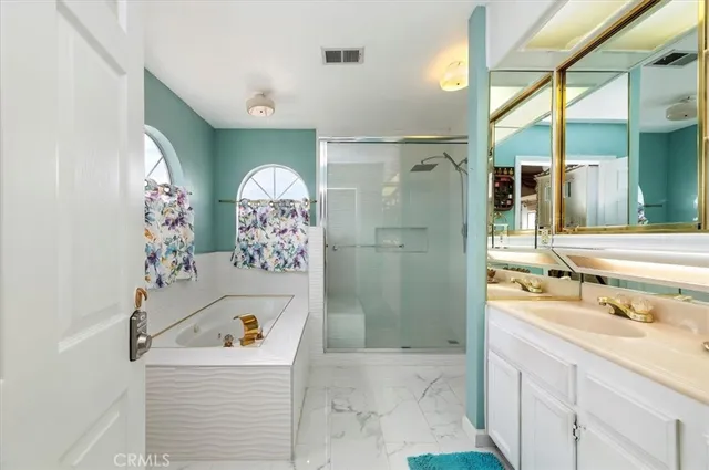 a bathroom with a sink mirror and shower