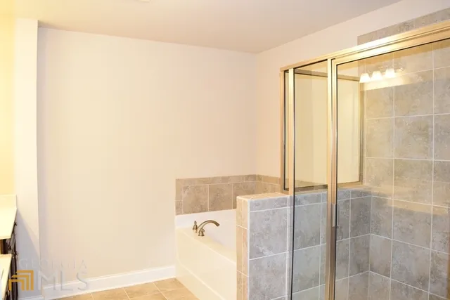 a bathroom with a shower and a tub