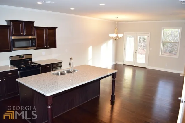 a kitchen with a sink a oven a refrigerator and a stove