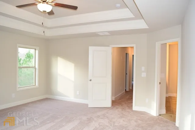 a view of a livingroom with a ceiling fan and window