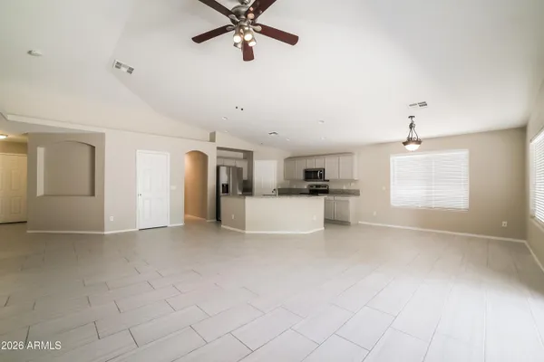 a view of a kitchen with a sink and a refrigerator