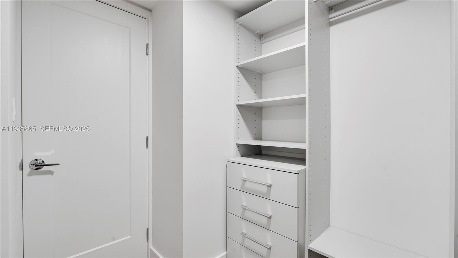 555 Northeast 34th Street, Unit 2209 Miami, FL 33137 - Photo 31 of 32 a kitchen with white cabinets and white appliances