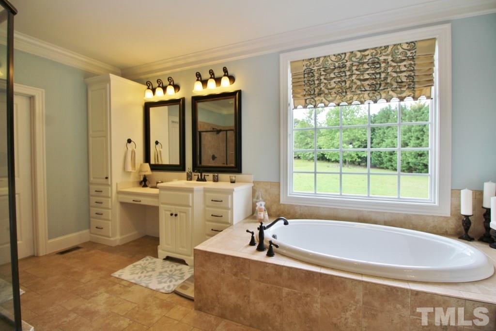 5820 Farmstead Road Bailey, NC 27807 - Photo 11 of 25 a spacious bathroom with sink bathtub and mirror