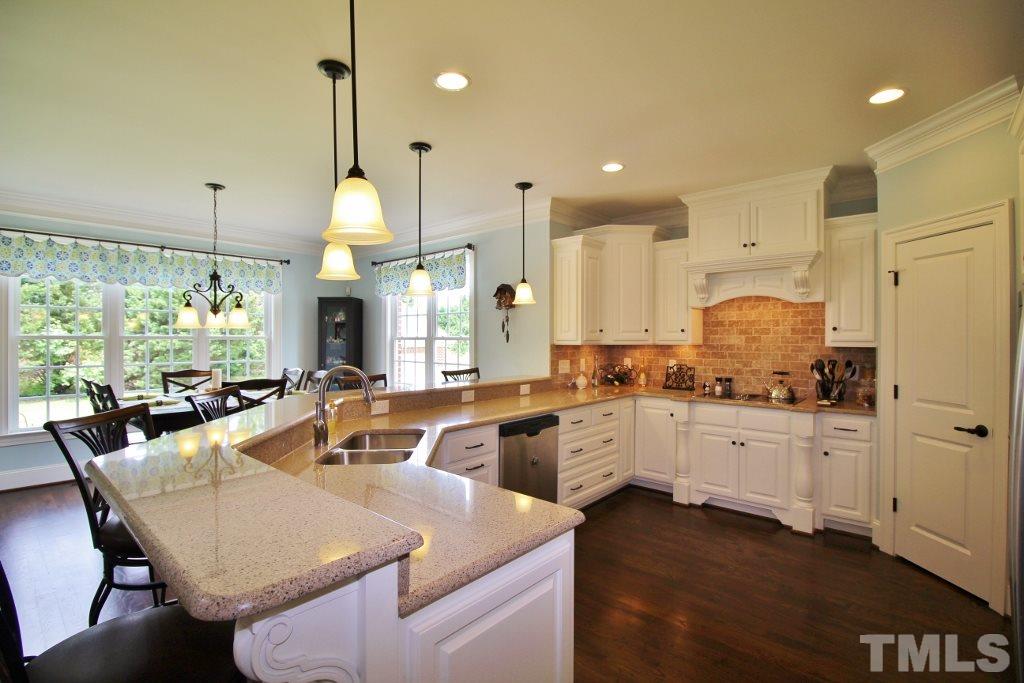 5820 Farmstead Road Bailey, NC 27807 - Photo 17 of 25 a kitchen with stainless steel appliances granite countertop a sink a stove and a refrigerator