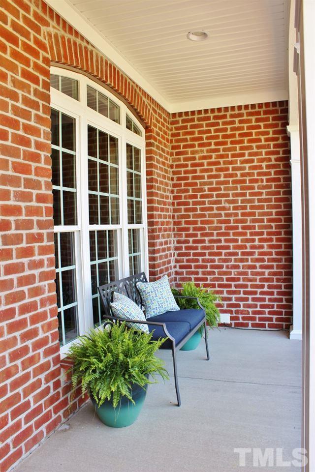 5820 Farmstead Road Bailey, NC 27807 - Photo 5 of 25 a brick building with a bench in front of door