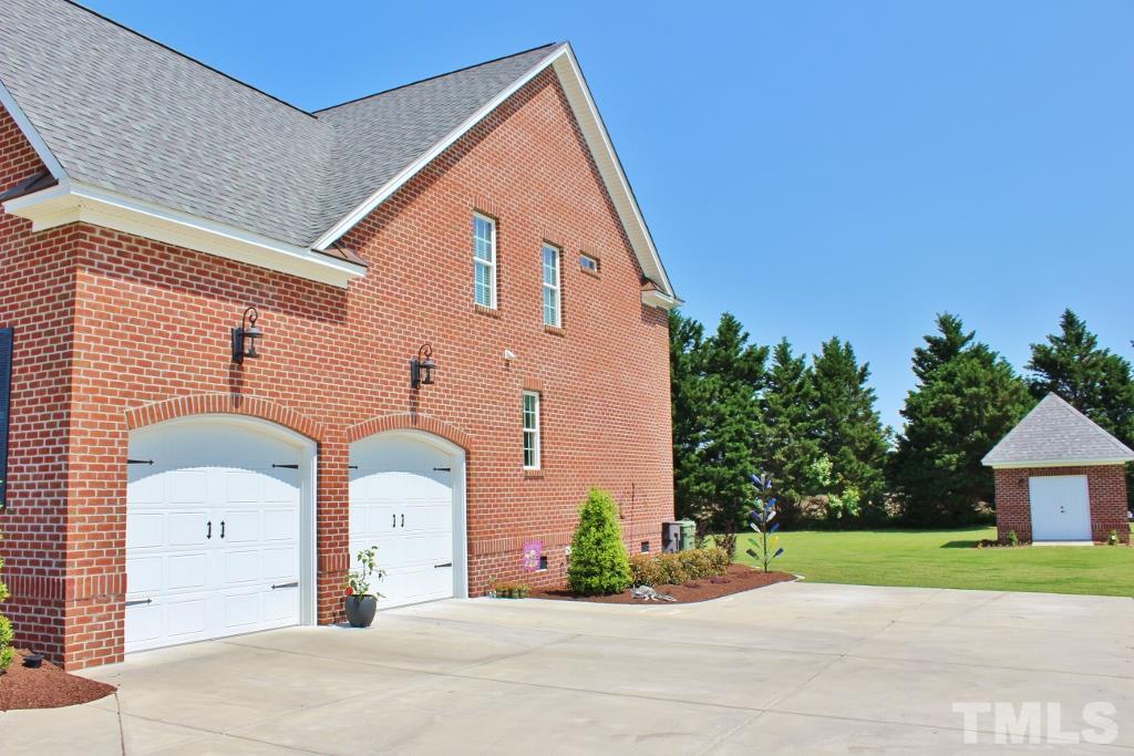5820 Farmstead Road Bailey, NC 27807 - Photo 6 of 25 a front view of a house with a yard and garage