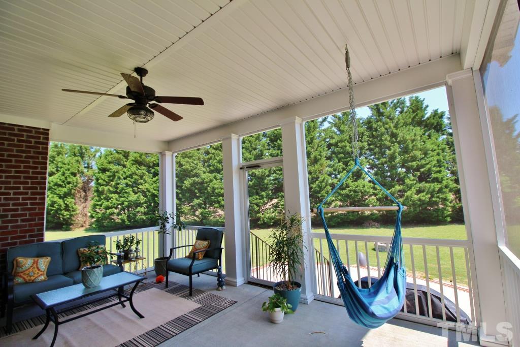 5820 Farmstead Road Bailey, NC 27807 - Photo 10 of 25 a living room with a floor to ceiling window and a table